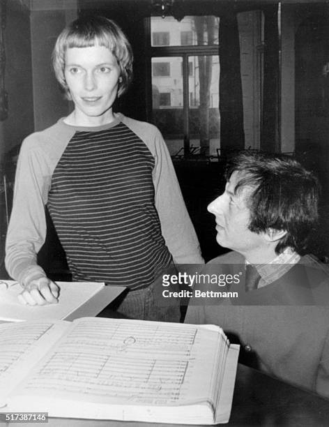 Actress Mia Farrow and her composer-conductor-pianist husband, Andre Previn, rehearse here for their Feb. 7th performance of honegger's oratorio st....
