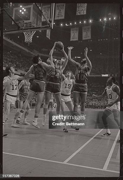 Celtic's Don Nelson, doesn't have a chance on this play, as three Knicks go up for a rebound under the Celtic's basket, with the Knicks Bill Bradley...