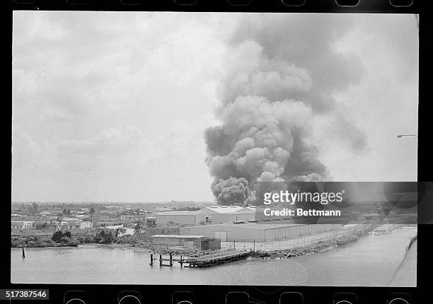 Saigon, South Vietnam: Black smoke billowing from the U.S. Agency for International Development compound at the northern edge of Saigon after it was...