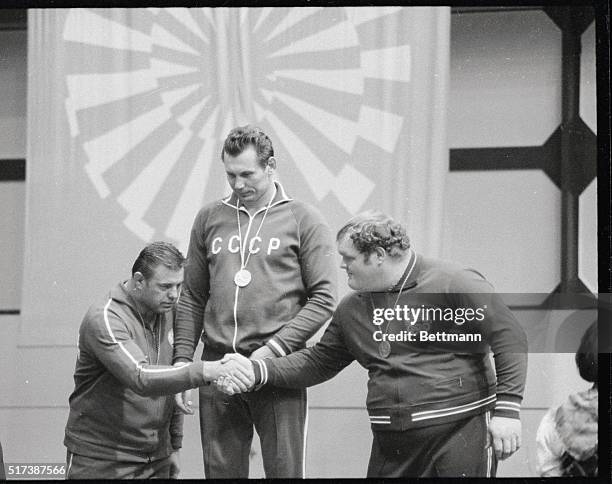 Standing on the podium after receiving their Olympic medals for the over 100 kg. Free style wrestling event are left to right: Osman Douraliev of...