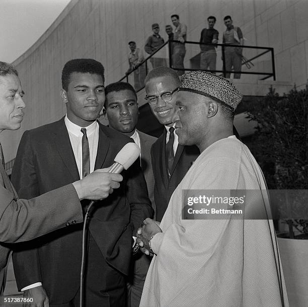 World heavyweight champion Mohammed Ali, formerly Cassius Clay, is interviewed by a reporter in front of the United Nations with his brother, Rudolph...