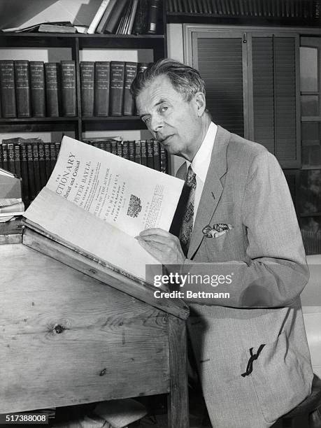 Portrait of novelist and essayist Aldous Huxley with dictionary of Peter Bayle. Photograph, 6/6/57.