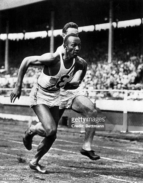 It's Owens again. London, England: Jesse Owens, fresh from his triumphs in the Olympics, is shown taking over the baton from M.I. Glickman, in the...