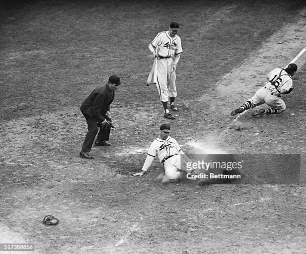 St. Louis, MO: Redbird outfielder Enos Slaughter slides across home plate with the winning run of the World Series during the eighth inning of the...