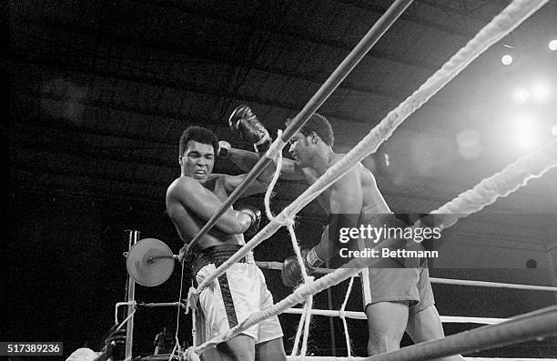 Heavyweight champion George Foreman and Muhammad Ali exchange punches during their world heavyweight title boxing match in 1974.