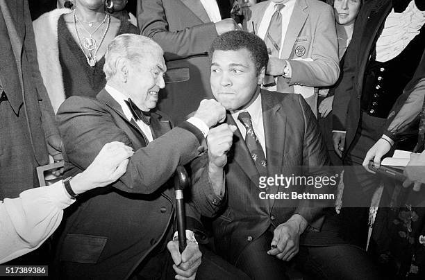 New York, NY- Jack Dempsey takes a poke at Muhammad Ali during the first Thurman Award Dinner of the Association for the Help of Retarded Children....