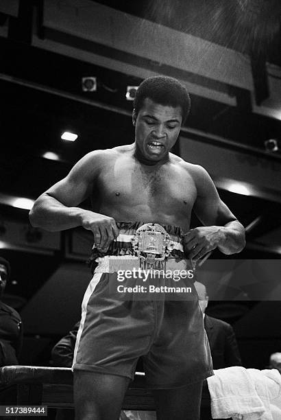 While strapping on his heavyweight championship title belt at a pre-fight physical, Muhammad Ali declares, "Joe Frazier doesn't have the real belt....