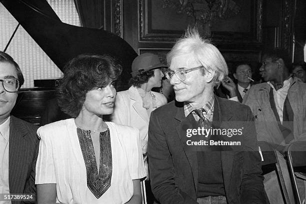 New York, New York-Bianca Jagger, ex-wife of Mick Jagger, shares a moment with pop artist Andy Warhol at the Metropolitan Club during a fashion show...