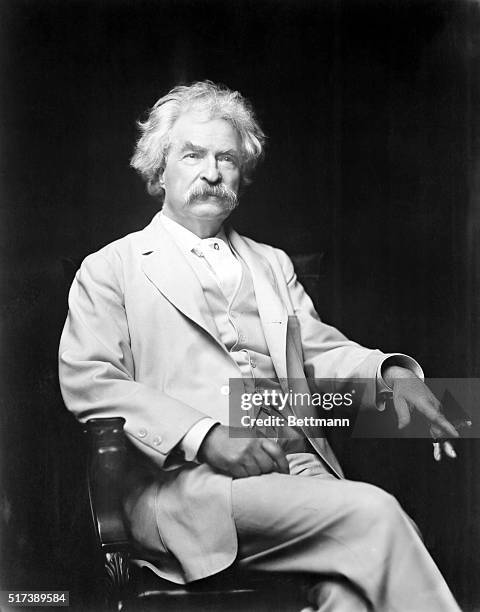 Mark Twain 1885-1910, lecturer and author of great literature. In this 3/4 length photograph he's seated holding a cigar, in a white suit. Undated.