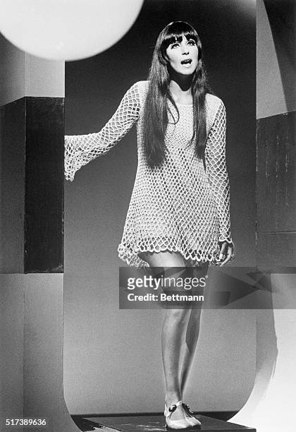 Cher Bono, of Sonny & Cher, performing during a TV guest appearance. She is shown full length, wearing a crocheted mini-dress.