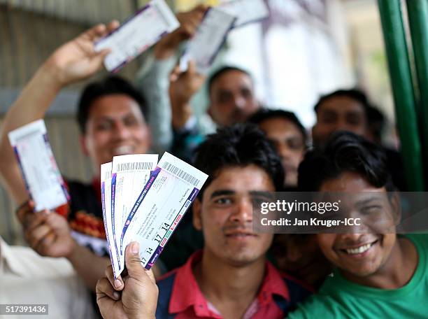 Fans pose with their tickets ahead of the ICC World Twenty20 India 2016 Super 10s Group 2 match between Pakistan and Australia at the IS Bindra...