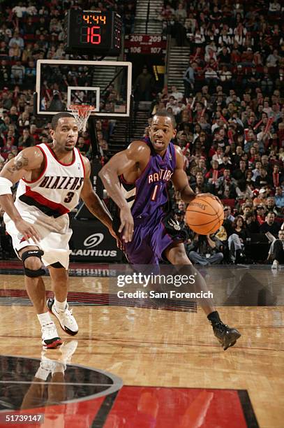 Rafer Alston of the Toronto Raptors takes the ball past Damon Stoudamire of the Portland Trail Blazers on November 13, 2004 at the Rose Garden Arena...