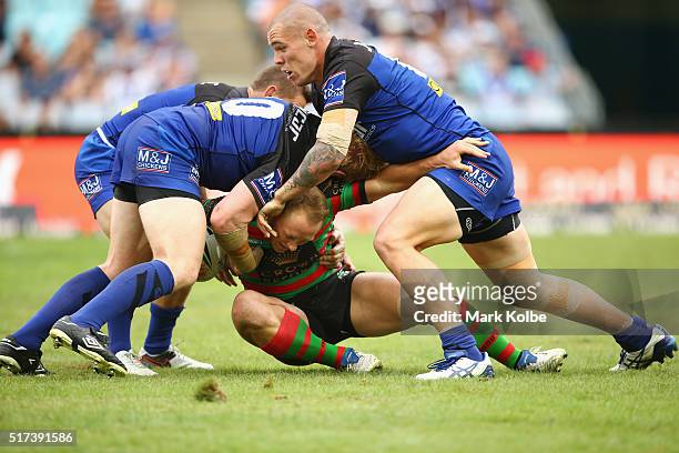 James Graham and David Klemmer of the Bulldogs tackle Jason Clark of the Rabbitohs during the round four NRL match between the South Sydney Rabbitohs...