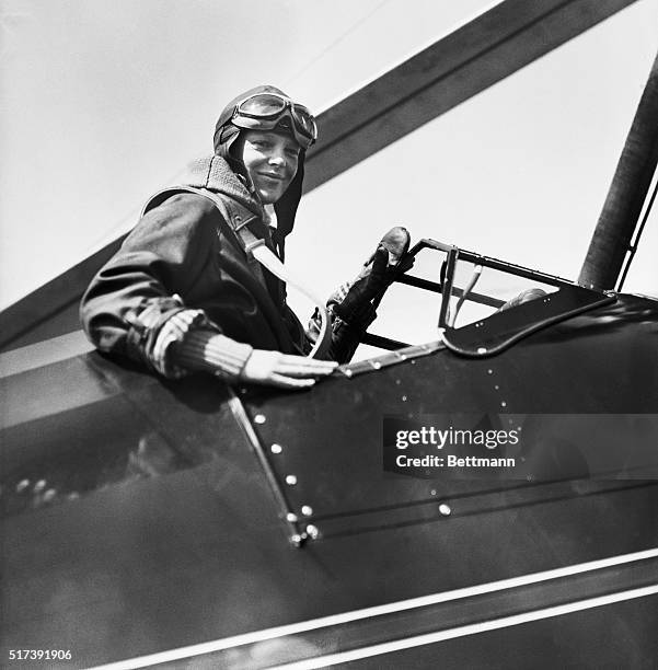 Philadelphia, Pennsylvania-Amelia Earhart in the cockpit of her autogiro after setting a new altitude record for women in planes of this type. She...