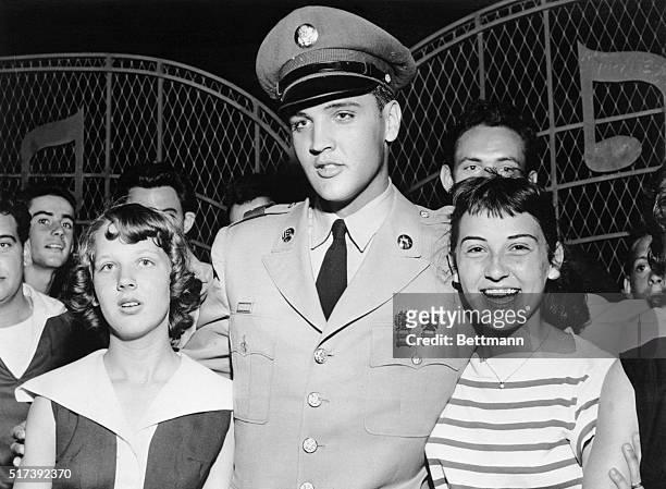 Memphis, TN- Jo Ann Mullins and Tudy Harrison greet singer Elvis Presley at the gate to his home. Presley made his first public appearance here since...