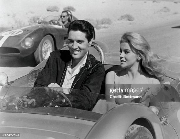 Elvis Presley and Ann-Margret in scene from the movie "Viva Las Vegas." They are riding a stock car. BPA2