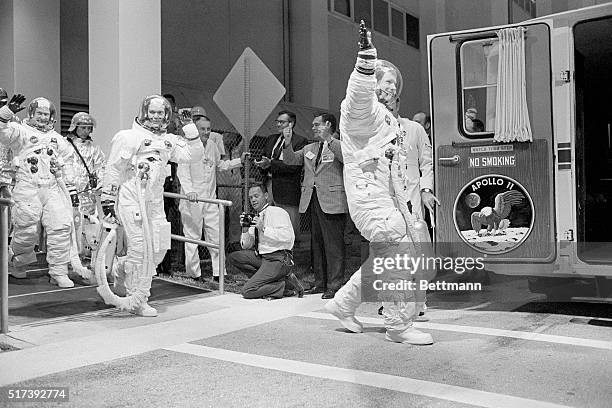 Kennedy Space Center, FL- Moon-bound Apollo 11 astronauts Buzz Aldrin, Mike Collins, and Neil Armstrong step from crew quarters en route to the...