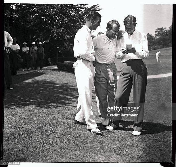 Three of the top-rank professional golfers in the country are shown here comparing cards after a practice round at the Oakwood Golf Course in...