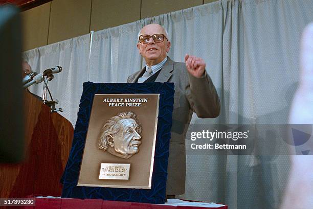 Washington, D.C.: Soviet nuclear physicist and human rights activist Andre Sakharov waves as he accepts the Albert Einstein Peace Prize.