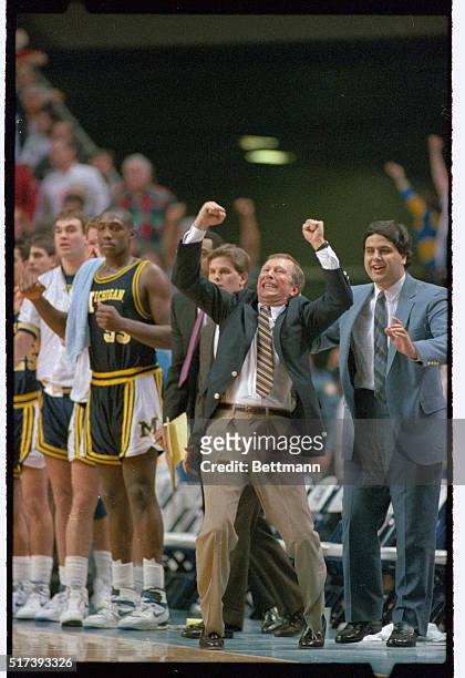Jubilant Michigan head coach Steve Fisher reacts as his team defeated North Carolina, 92-87 at Rupp Arena, March 23rd. The interim coach will take...