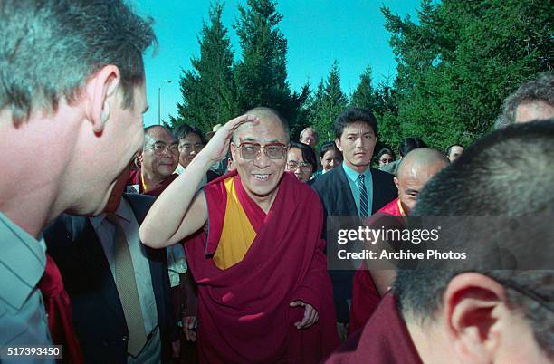 San Rafael, Calif.: The Dalai Lama shields his eyes from the sun as he arrives on top of Mount Tamalpais near San Francisco to perform a traditional...