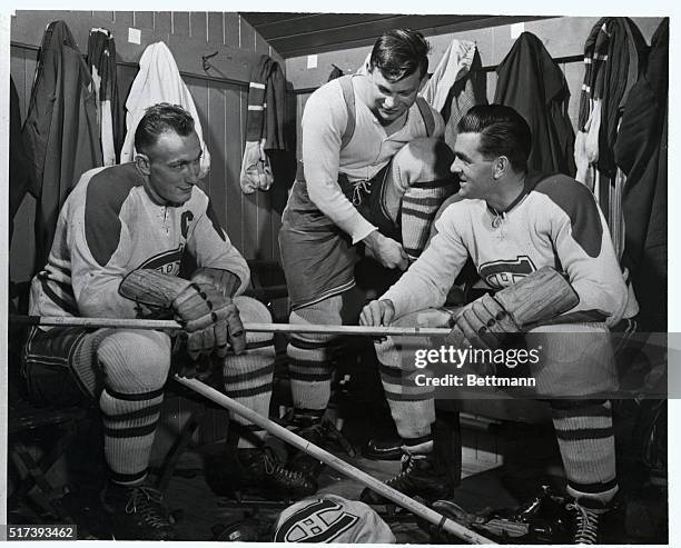 Colin and another rookie, Jim McPherson , who is also from Edmonton, get some advice on stick-handling from a veteran expert, Maurice "The Rocket"...