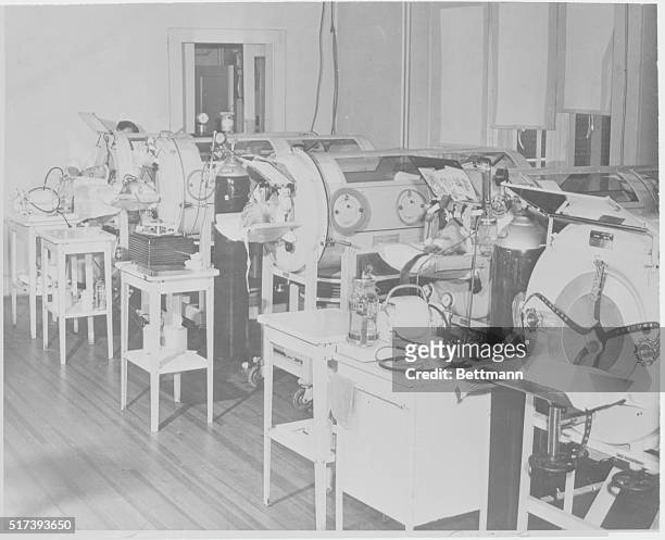 Little Rock, Arkansas: Polio Patients Crowded. Polio epidemic conditions necessitated the close crowding of these respirators in the polio ward at...