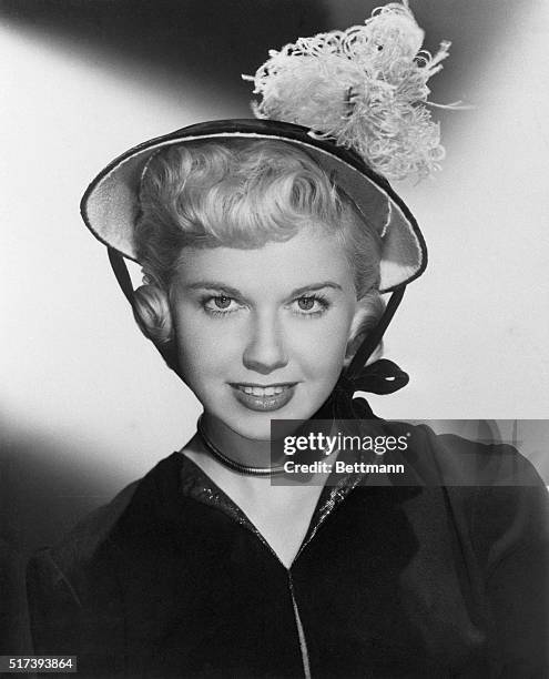 Doris Day, starring in my dream is yours, models one of the most endearing hats in De Villar's fall collection. The small scoop bonnet of Empire...