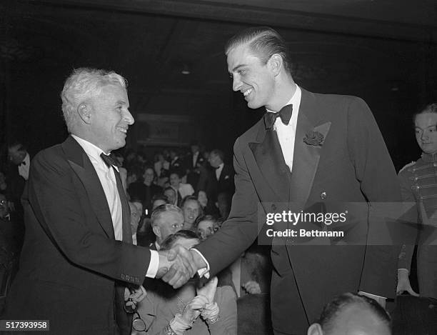 Swell Job, Charlie." New York, New York: Franklin D. Roosevelt, Jr., right, son of the president of the United States, congratulates actor producer...