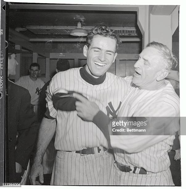 Yankee Manager Casey Stengel hugs second baseman Gerry Coleman after the Yanks beat the Boston Red Socks, 5-3, to take the American League Pennant....