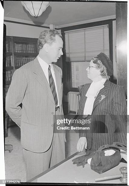 Dr. Peter Lindstrom chats with a corroborating witness, Mrs. Phyllis Seaton, in Superior Court, after he was granted a divorce from screen star...