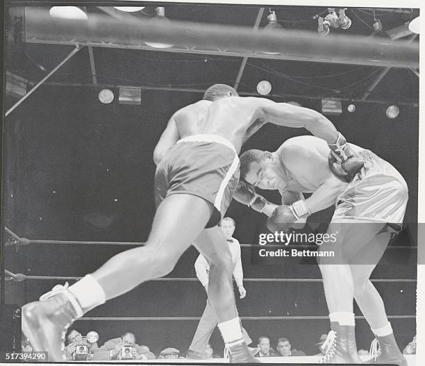 New York: Belt In The Back. Joe Louis flinches as he takes a hard right to the kidney delivered by Ezzard Charles in the 6th round of their...