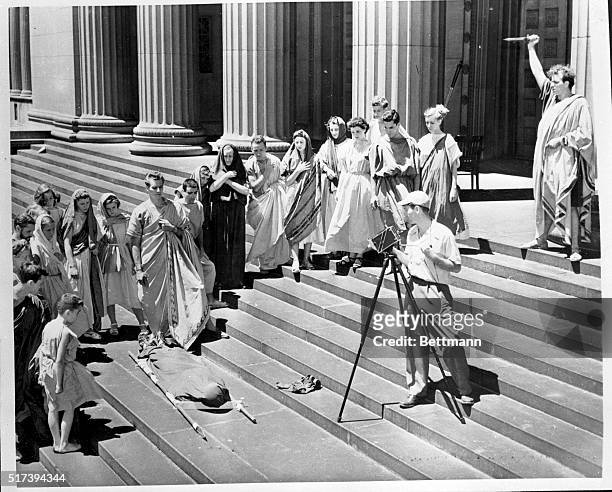 The steps and columns of Chicago's Museum of Science and Industry make an authentic Roman setting for the death scene in "Julius Caesar." Rehearsing...