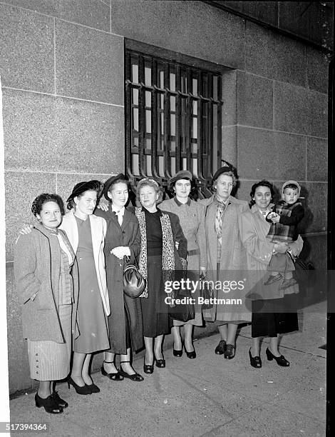 Some of the wives of the 11 convicted American Communists wait outside the Federal Court Building in new York Nov. 3 following the announcement that...