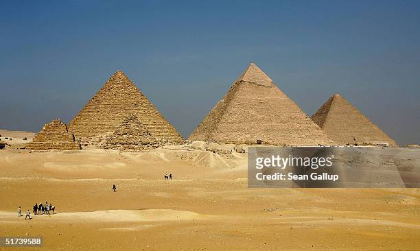 The three large pyramids of Menkaure , Khafre and Khufu loom over the horizon November 13, 2004 at Giza, just outside Cairo, Egypt. The three large...