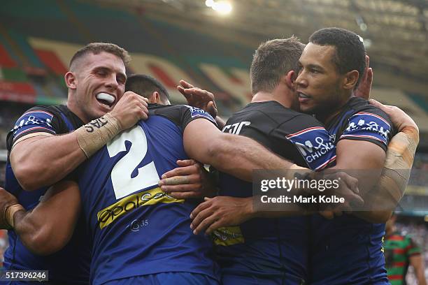 Adam Elliott, Curtis Rona, Josh Morris and Moses Mbye of the Bulldogs celebrate Curtis Rona scoring a try during the round four NRL match between the...