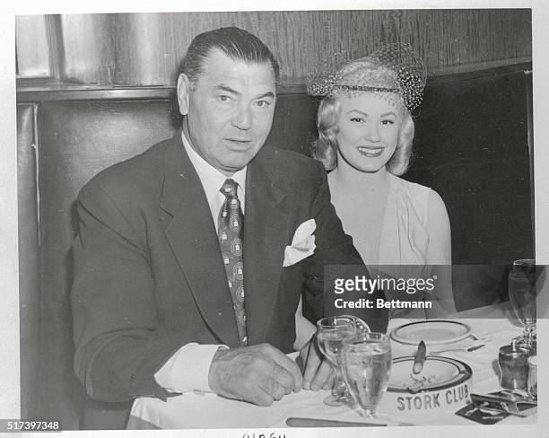 Jack Dempsey, the former world's heavyweight champ, and model , Mamie Van Doren relax at the Stork Club in this photograph, where Dempsey is still a...