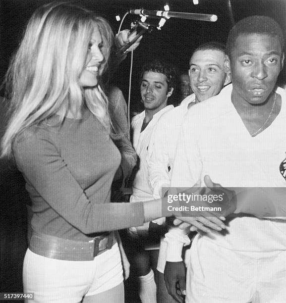 Soccer king Pele , of Brazil, and other team members meet French film star Brigitte Bardot at Colombes Stadium here March 31st during a charity match...