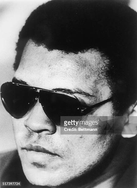 Defeated WBC heavyweight champion Muhammad Ali with a swollen face and dark glasses during a mid-day press conference. Larry Holmes beat Ali in the...