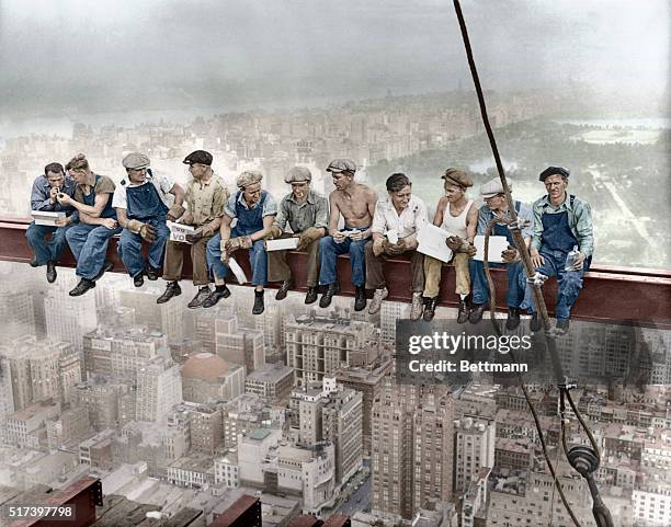 Sep 1932, Manhattan, New York City, New York State, USA --- Construction workers eat their lunches atop a steel beam 800 feet above ground, at the...