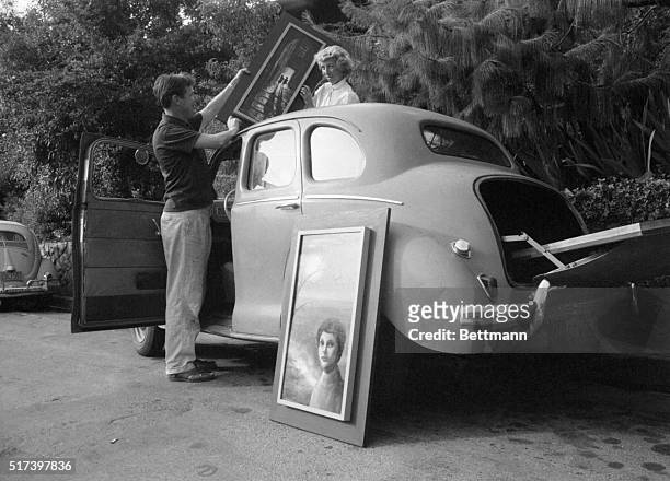 With a whole family supply of art to carry around, the Keanes' small foreign car sees plenty of use. The opening in the roof is handy for the long,...