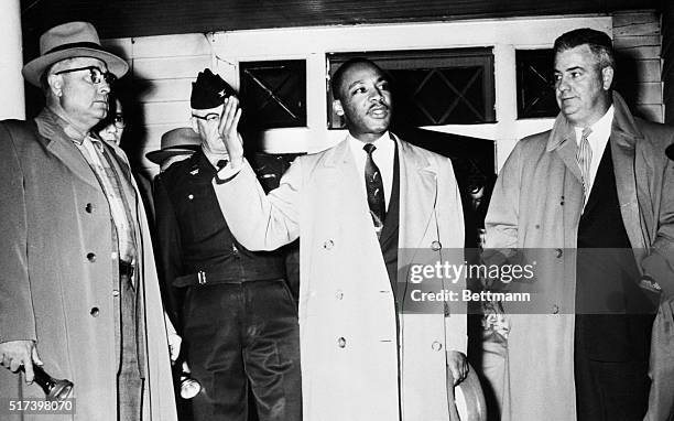 Reverend Martin Luther King Jr. , leader of an African American boycott against the Montgomery City Buses, urges calmness from the porch of his home,...