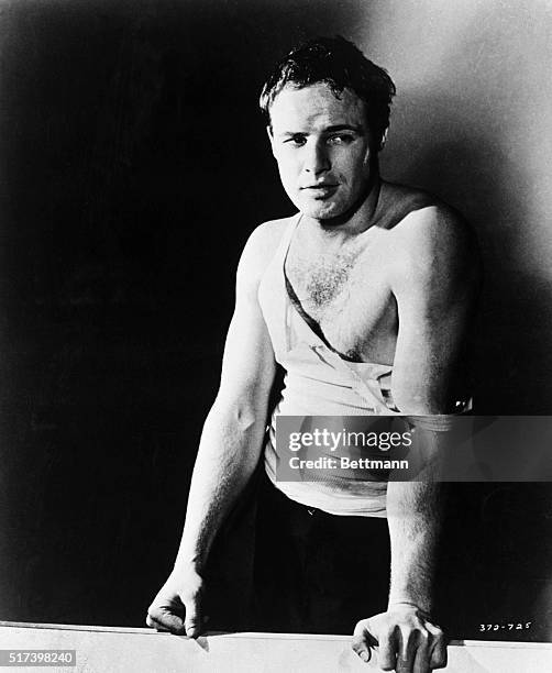 Marlon Brando as he appeared in the 1951 film, "A Streetcar Named Desire." He is shown wearing a ripped white tank shirt.