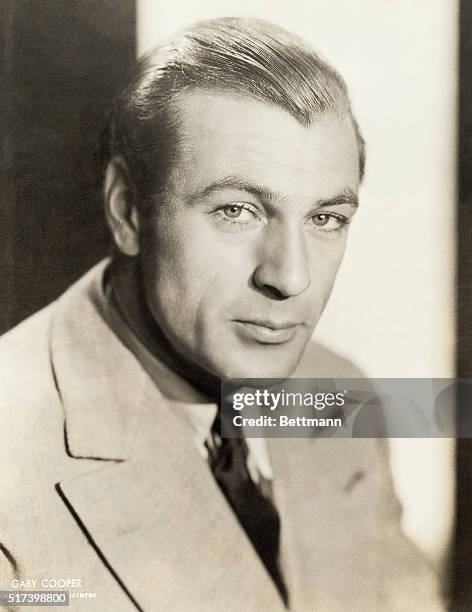 Paramount Pictures publicity portrait of actor Gary Cooper. He is shown in a head-and-shoulders view, wearing a suit and tie. Photograph, circa 1940.