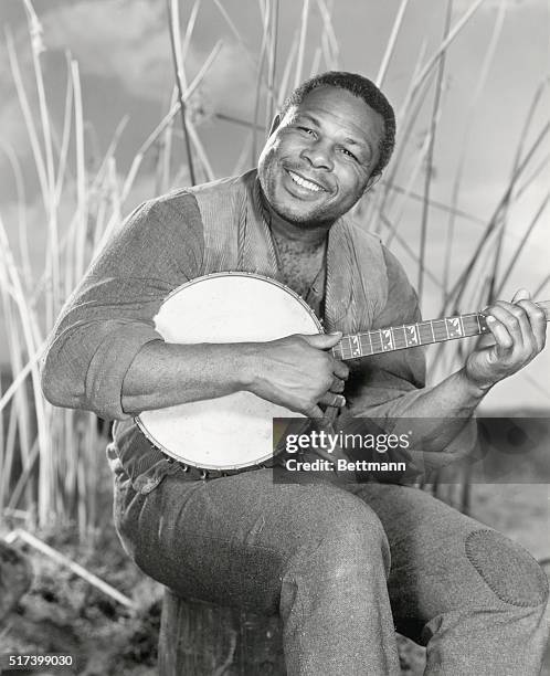 World's Light Heavyweight Champion boxer, Archie Moore, makes his film debut as the runaway slave "Jim" in the movie, "The Adventures of Huckleberry...