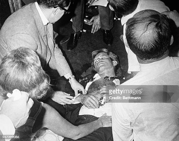 Clutching his rosary beads, Senator Robert F. Kennedy lies wounded on the floor of the Ambassador Hotel, after being shot by an assailant, following...
