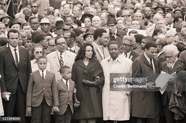 Memphis, TN- Mrs. Martin Luther King, Jr., on the arm of Dr. Ralph Abernathy, her husband's successor as head of the Southern Christian Leadership...