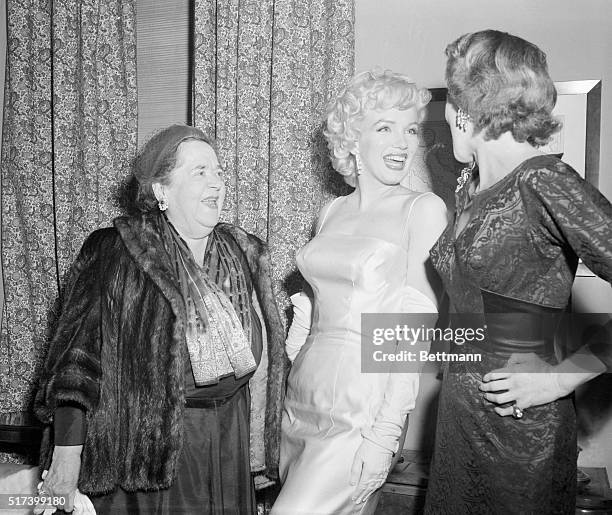 Cocktail party in the home of attorney Frank Delaney. Left to right; Elsa Maxwell, Marilyn Monroe and Mrs, Frank Delaney