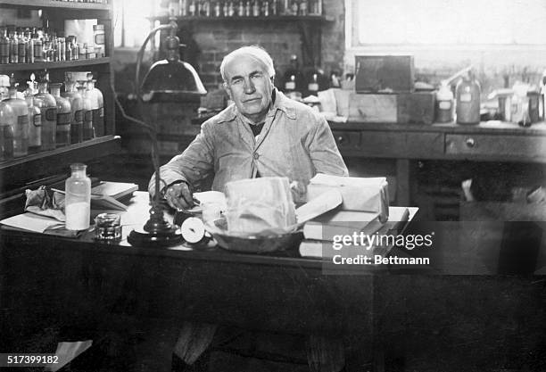 Photo shows Thomas Edison seated at his desk in a chemical laboratory. Undated.