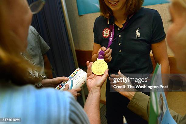 August 29: Olympic gold medalist Katie Ledecky lets fans touch her medal at a reception in her honor at the Montgomery County offices in Rockville,...